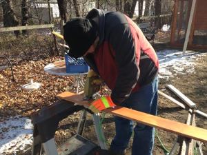 Matt trims a piece of wood using a jig saw.