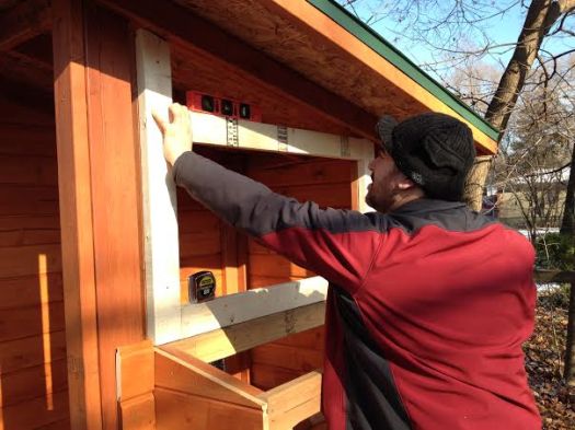 Matt measures the framing for a window.