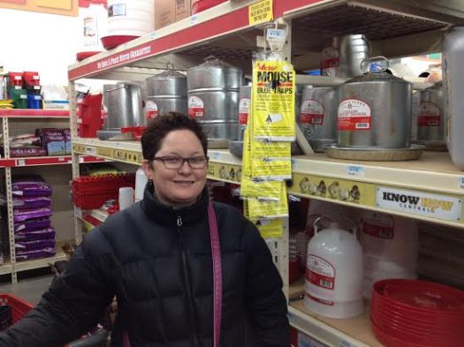 Jilli checks out the feed and water containers in the chicken section of TSC.